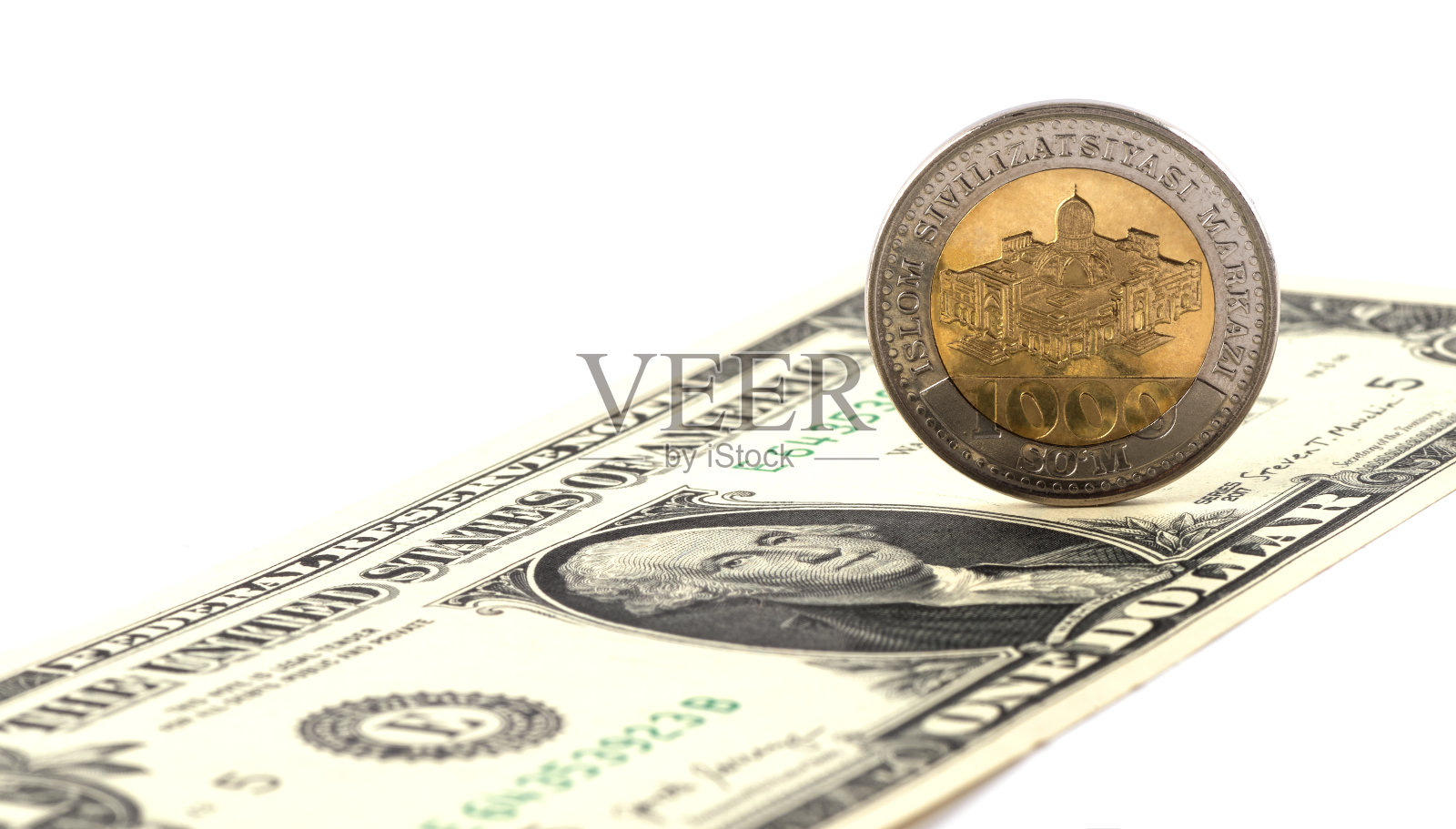 1000乌兹别克硬币和1美元纸币照片摄影图片