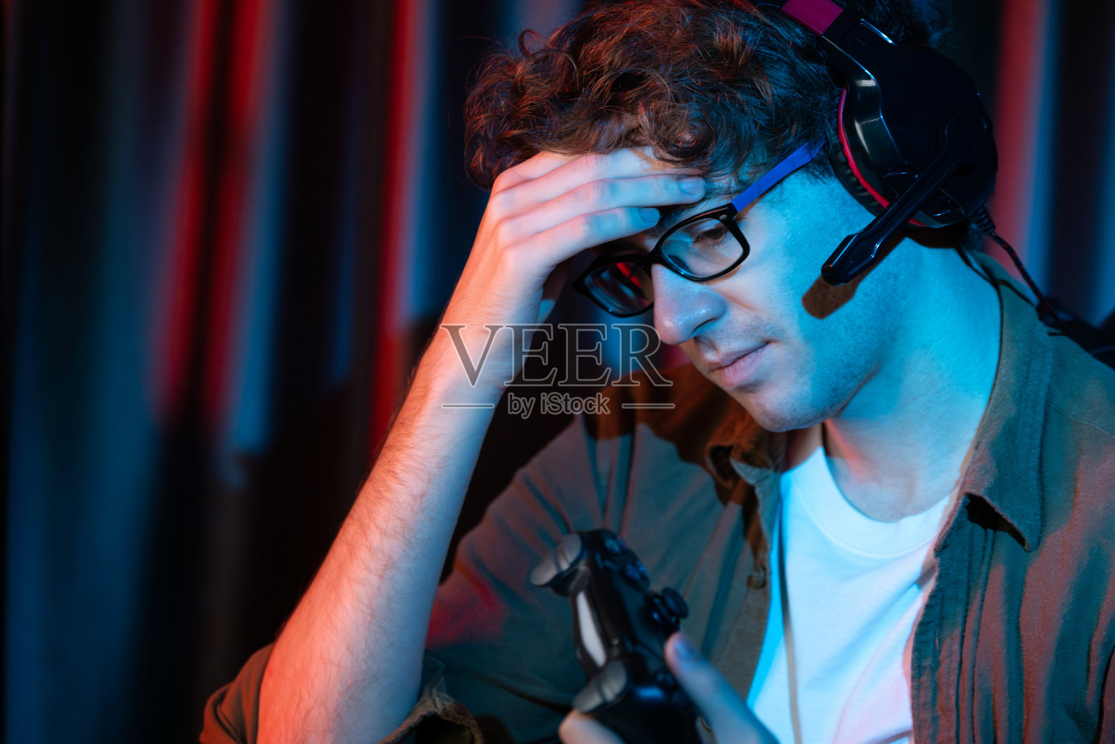 流播放与操纵杆电子竞技队在电脑上与更难的游戏。自喷井。照片摄影图片