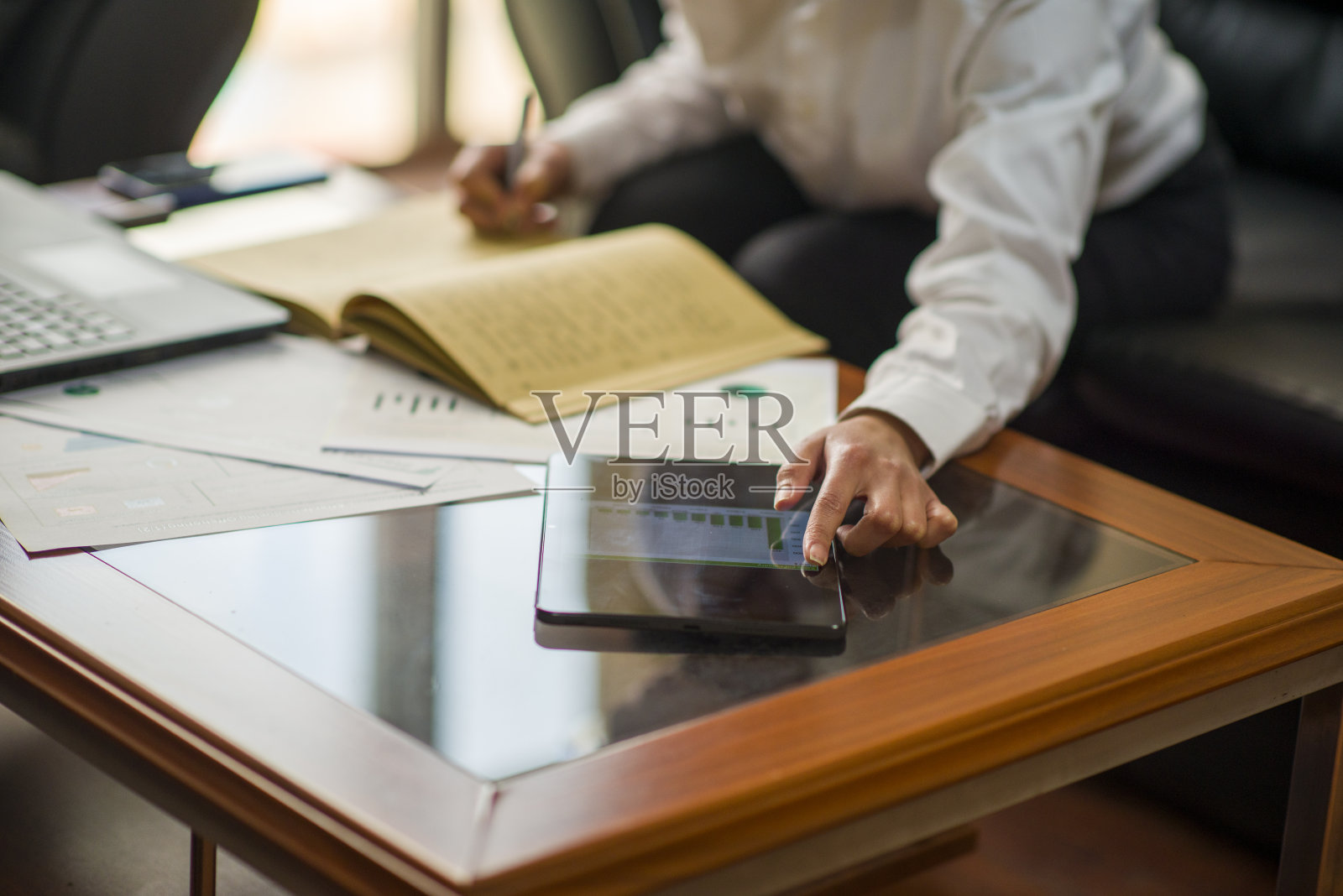 在办公环境中坐在办公桌前工作的女商人照片摄影图片