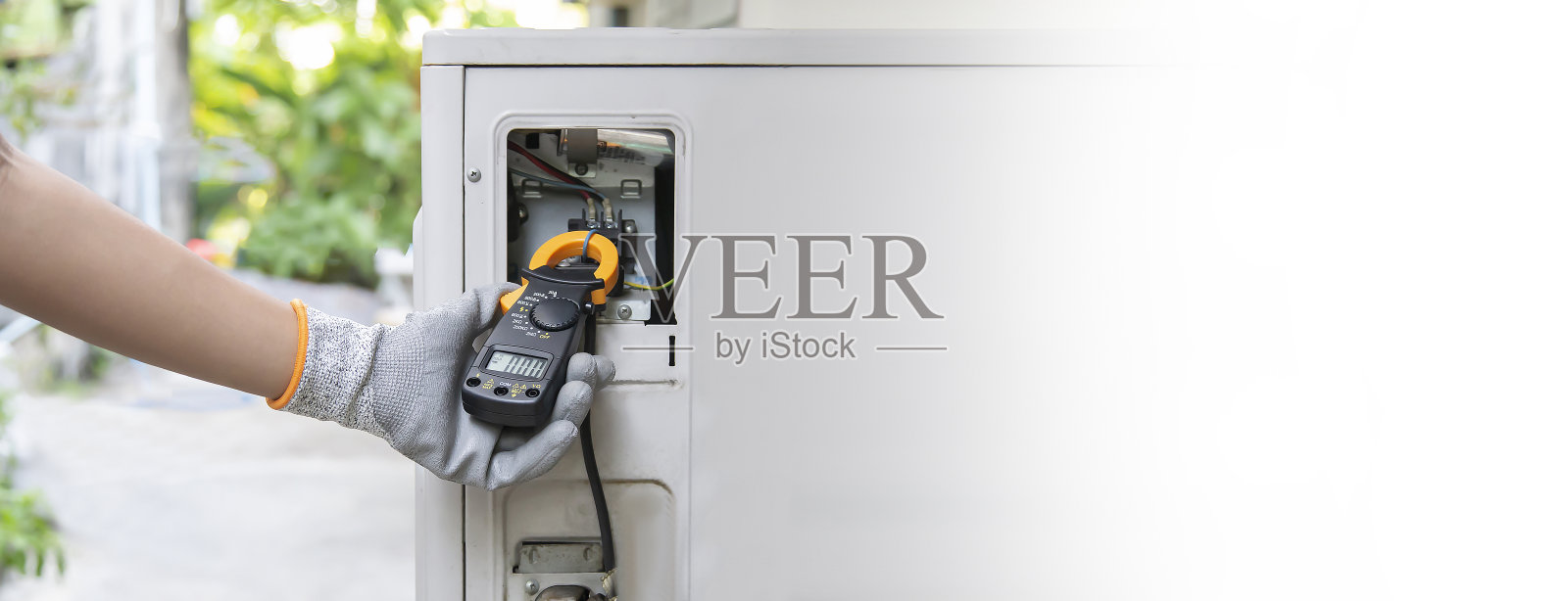 空调,暖通空调维修技术员使用仪表检查制冷剂并添加制冷剂。照片摄影图片