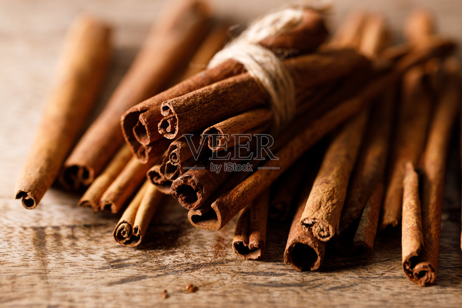 肉桂棒干树皮香料在质朴的木桌背景。有选择性的重点。照片摄影图片