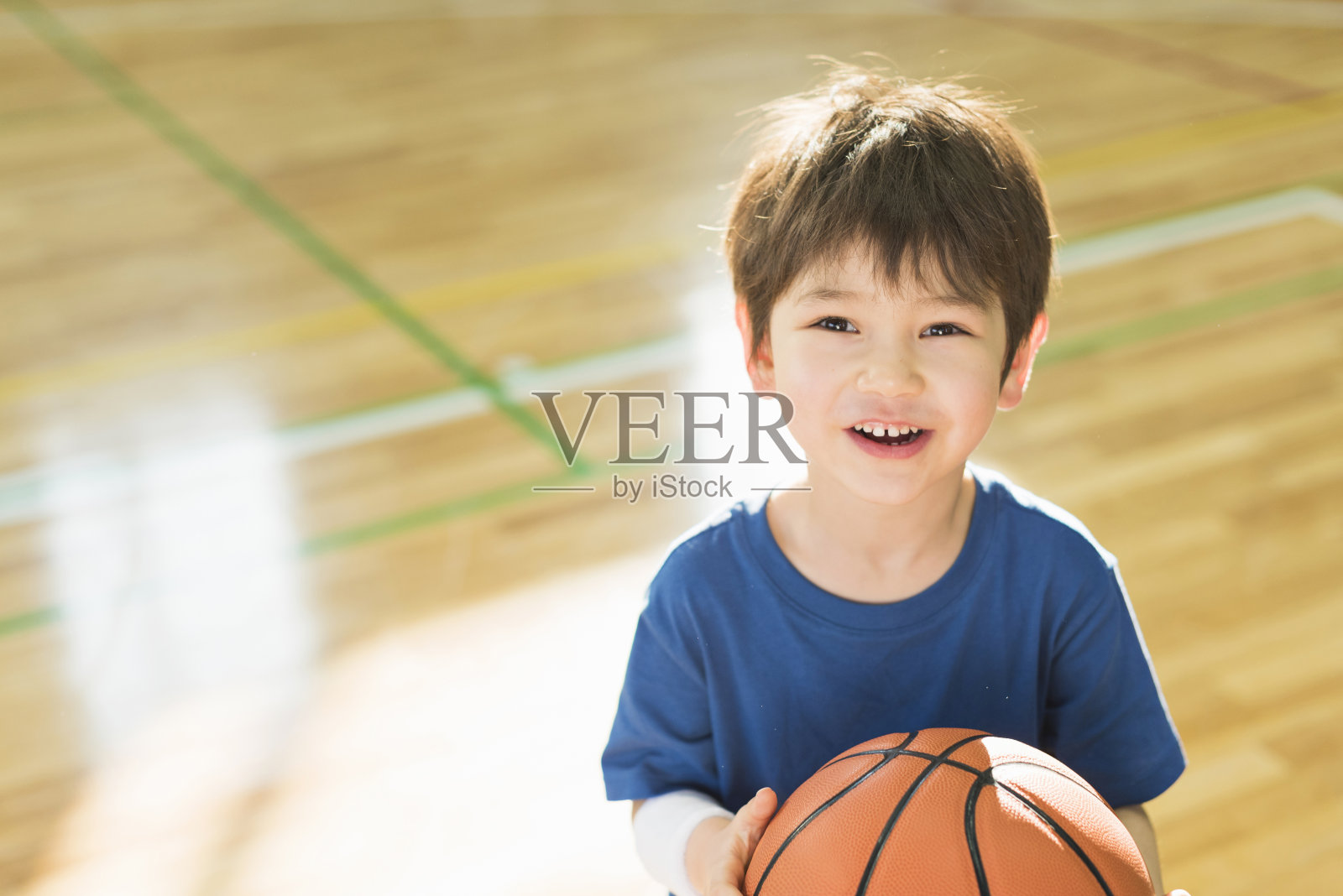 男孩们在体育馆打篮球。照片摄影图片