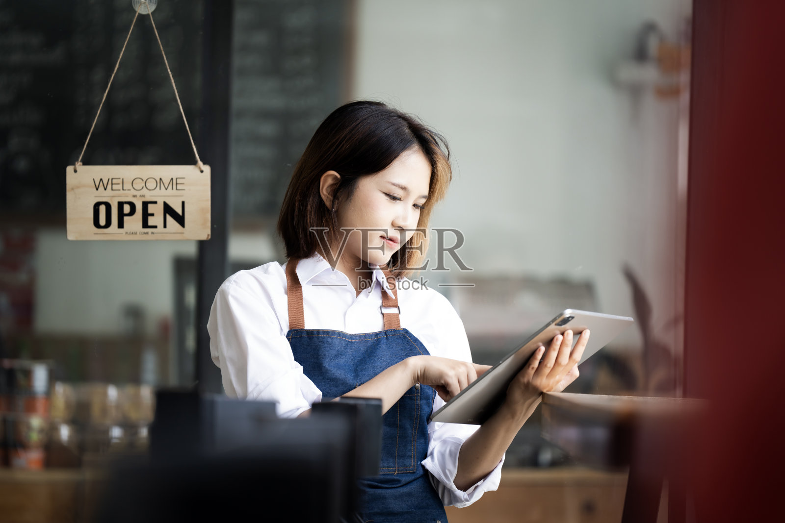 小企业主sme美女女孩站在咖啡厅餐厅用平板电脑智能手机。亚洲黑人女咖啡师咖啡馆老板的肖像。中小企业企业家卖主经营理念照片摄影图片