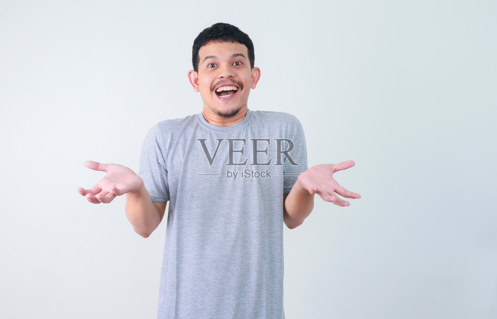 哇,震惊的亚洲人的脸指向目前空白的内容。广告模式概念。照片摄影图片