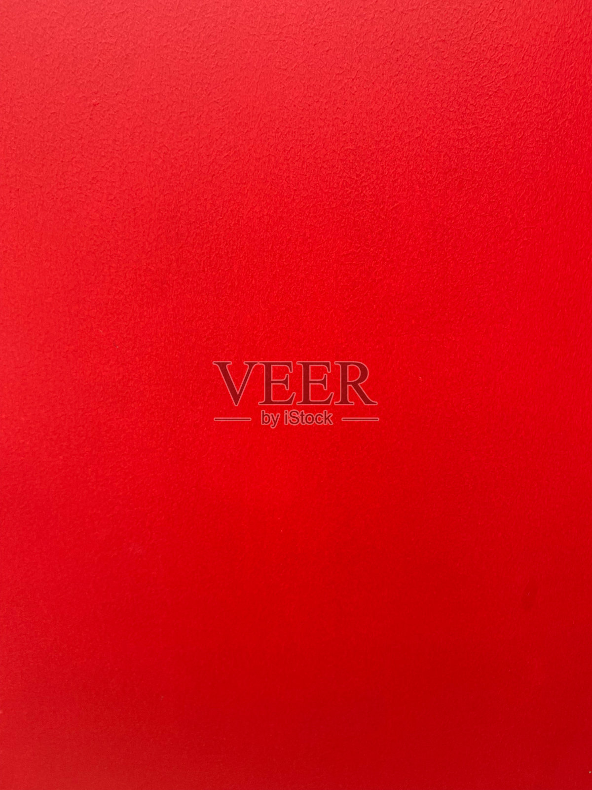 一个充满活力的红色纹理表面的特写,为各种设计和艺术项目提供了大胆而引人注目的背景。照片摄影图片