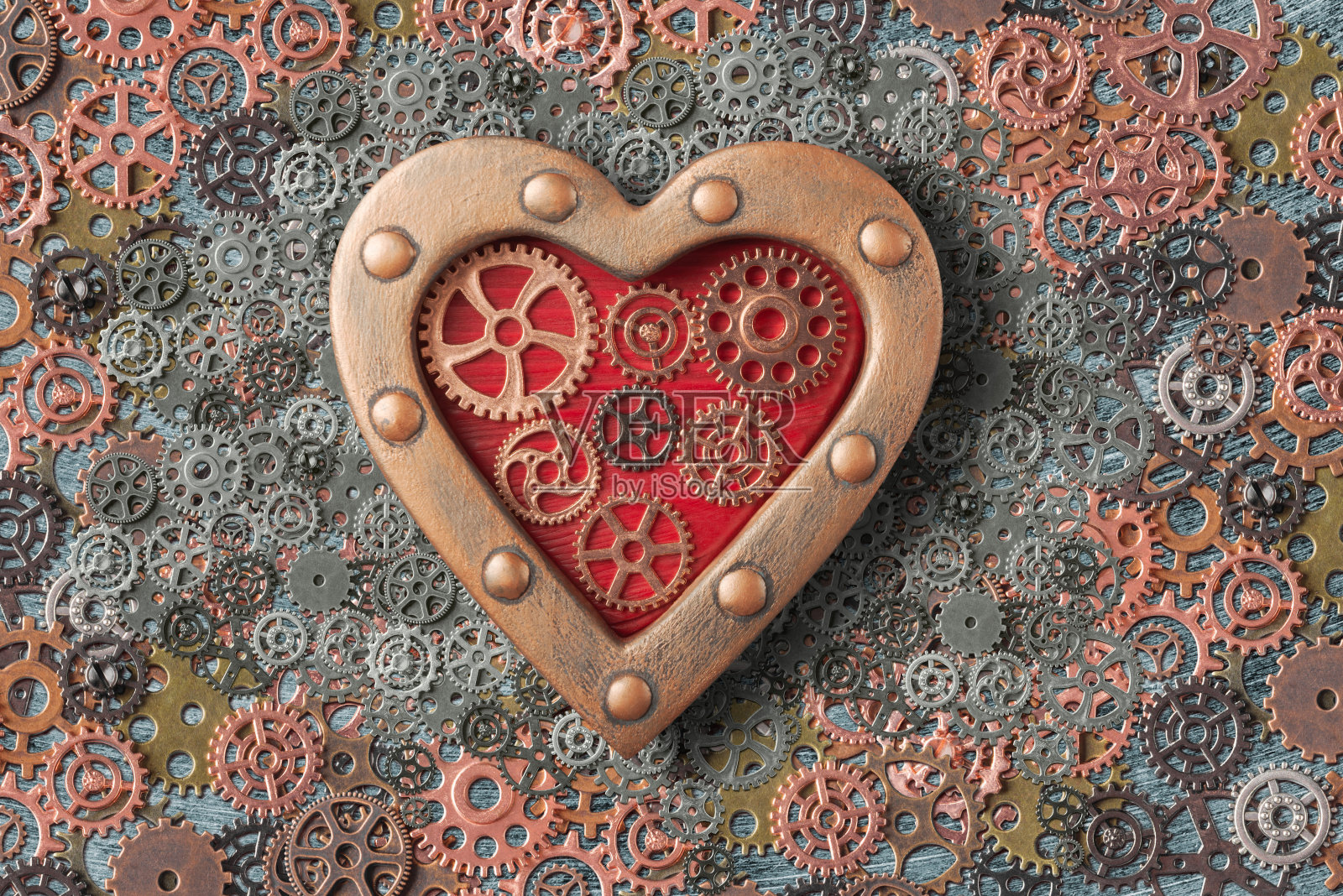蒸汽朋克在背景上用齿轮装饰心脏。蒸汽朋克风格的情人节概念照片摄影图片