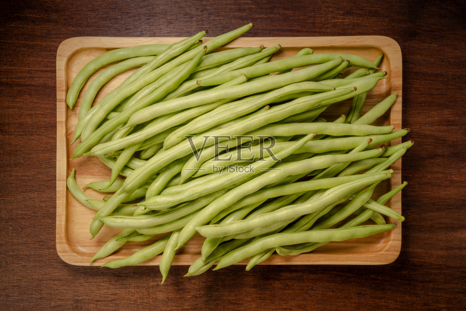 木底木盘青豆或青豆,木桌木篮青豆或法式青豆。照片摄影图片