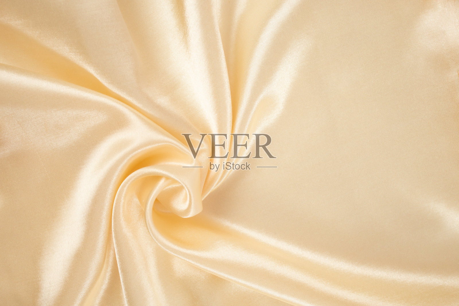 金色奶油色缎面布安排漩涡,抽象纹理背景照片摄影图片