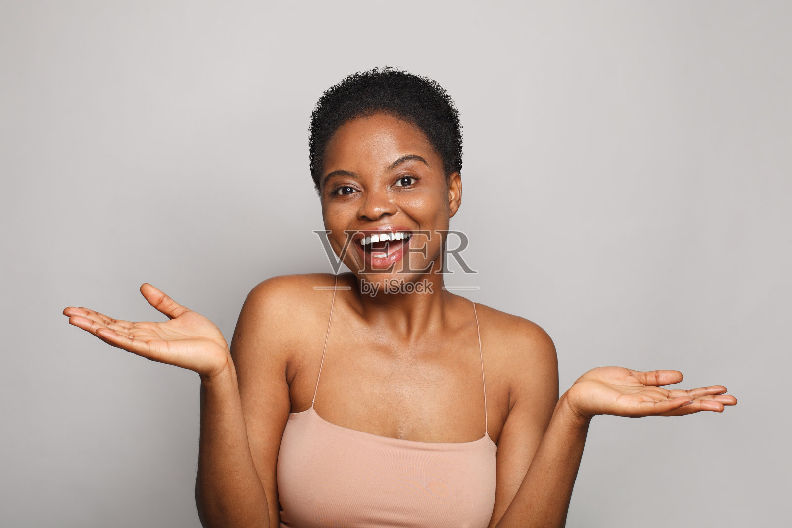 惊讶快乐的年轻女子捧着空空的手掌。广告、植入式广告、医药和治疗理念照片摄影图片