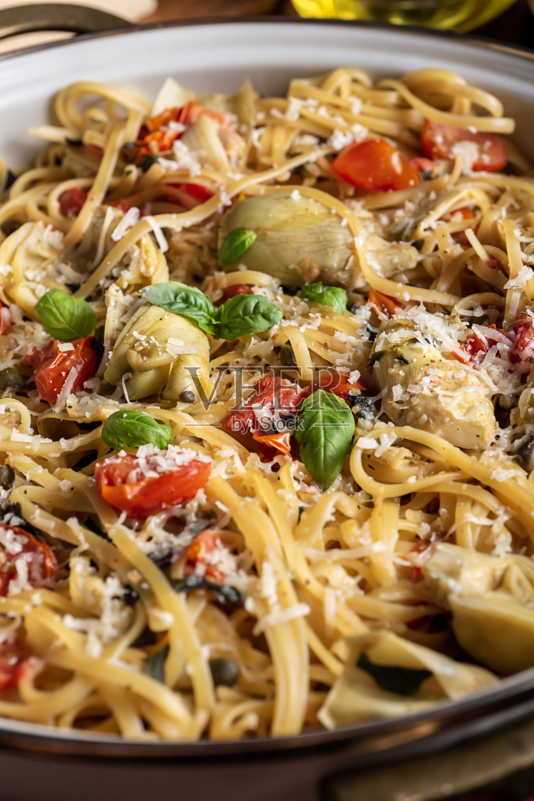 意大利面朝鲜蓟番茄煎锅照片摄影图片