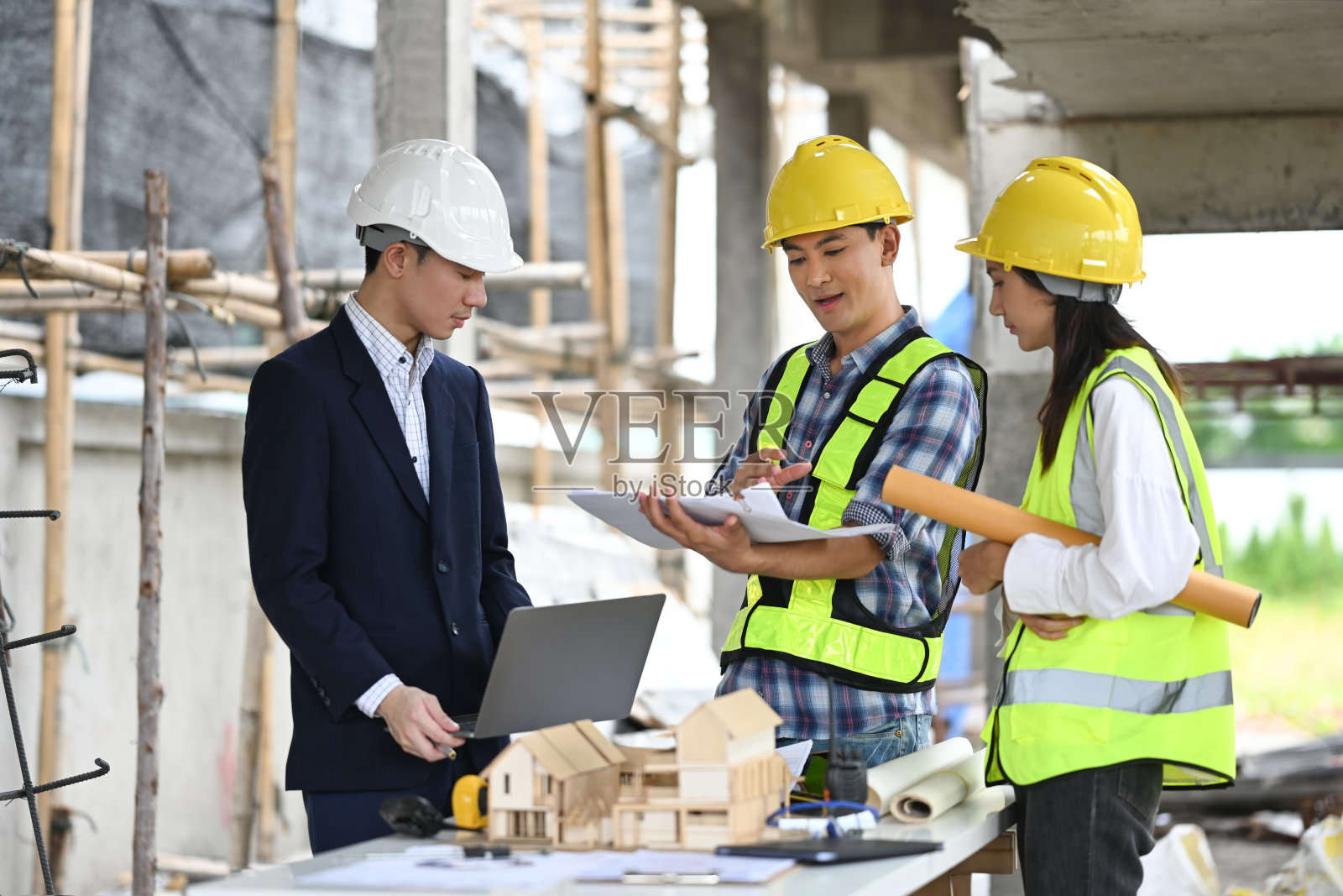 男性项目经理和工程师在建筑工地讨论项目细节照片摄影图片