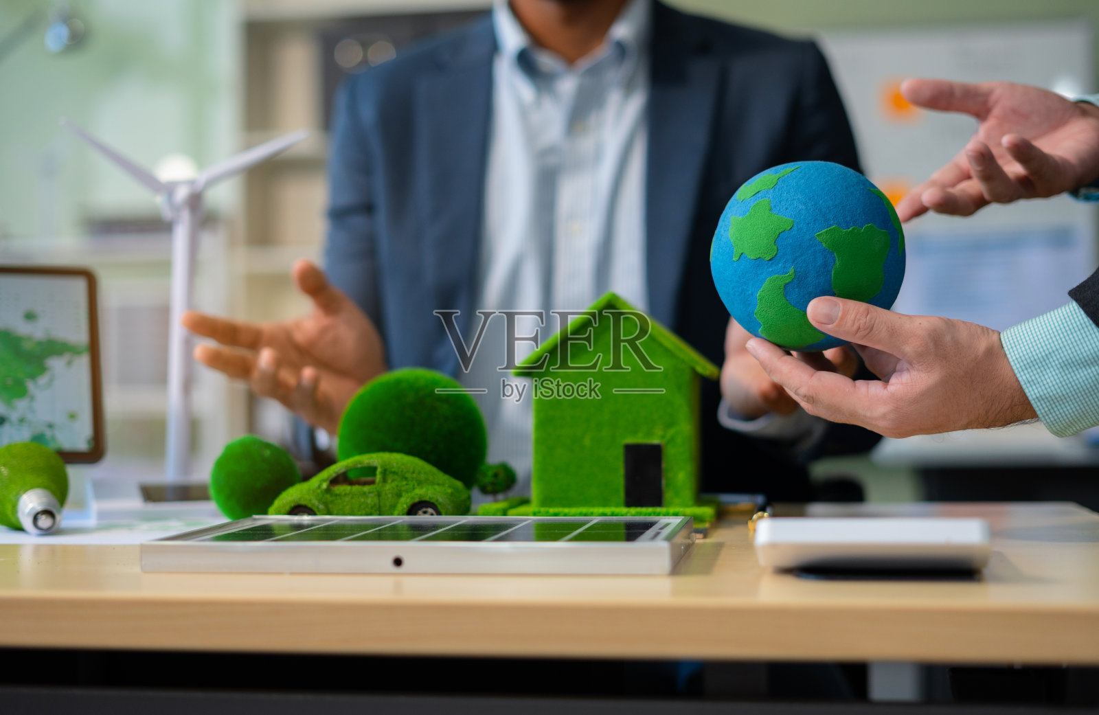 两位同事讨论数据工作和平板电脑,笔记本电脑与建筑工地项目,可再生能源和可持续发展,以及太阳能电池板的概念。照片摄影图片