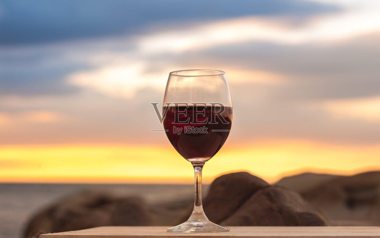 日落时酒杯对着天空的特写照片摄影图片