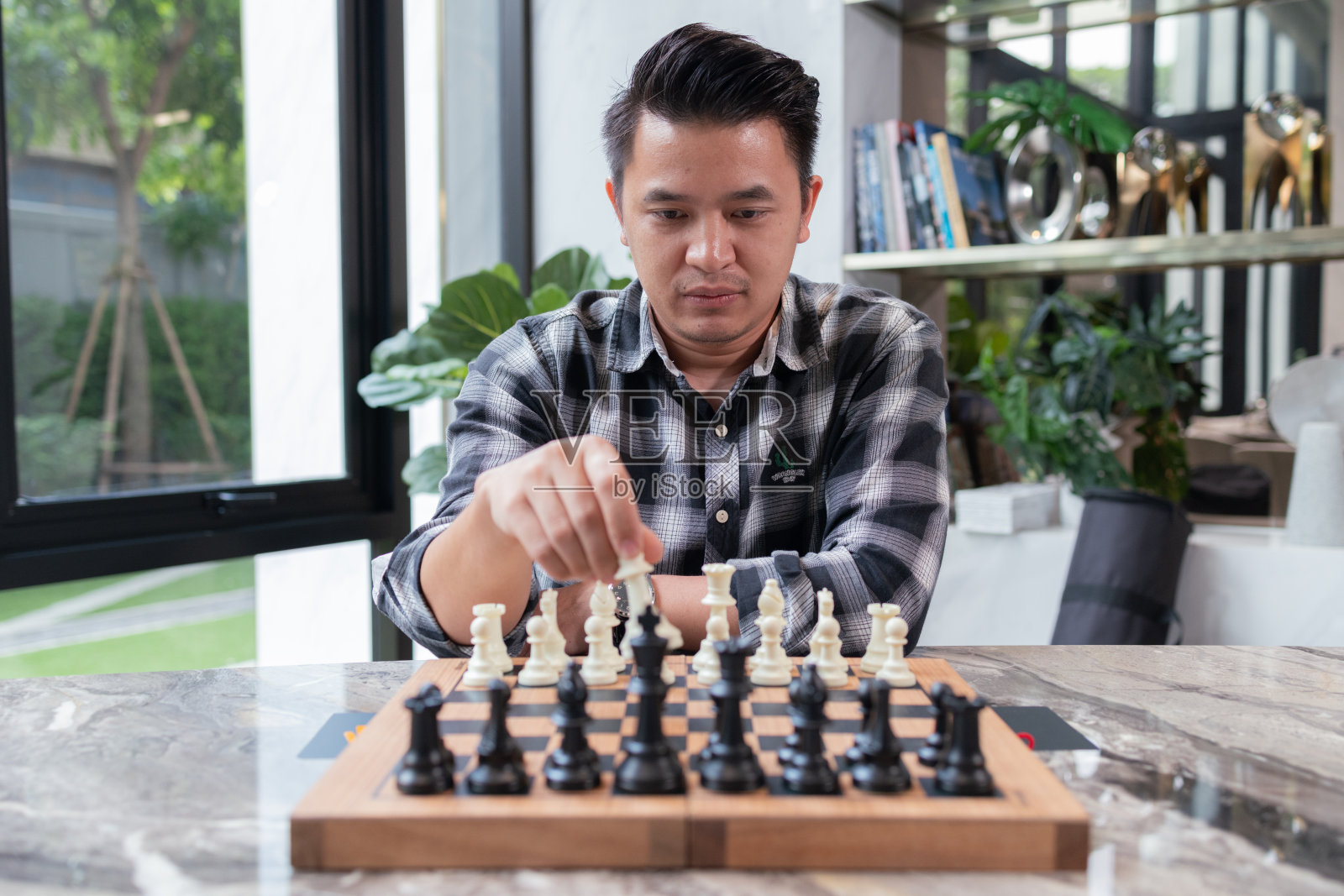 一个人在深思熟虑地下棋照片摄影图片