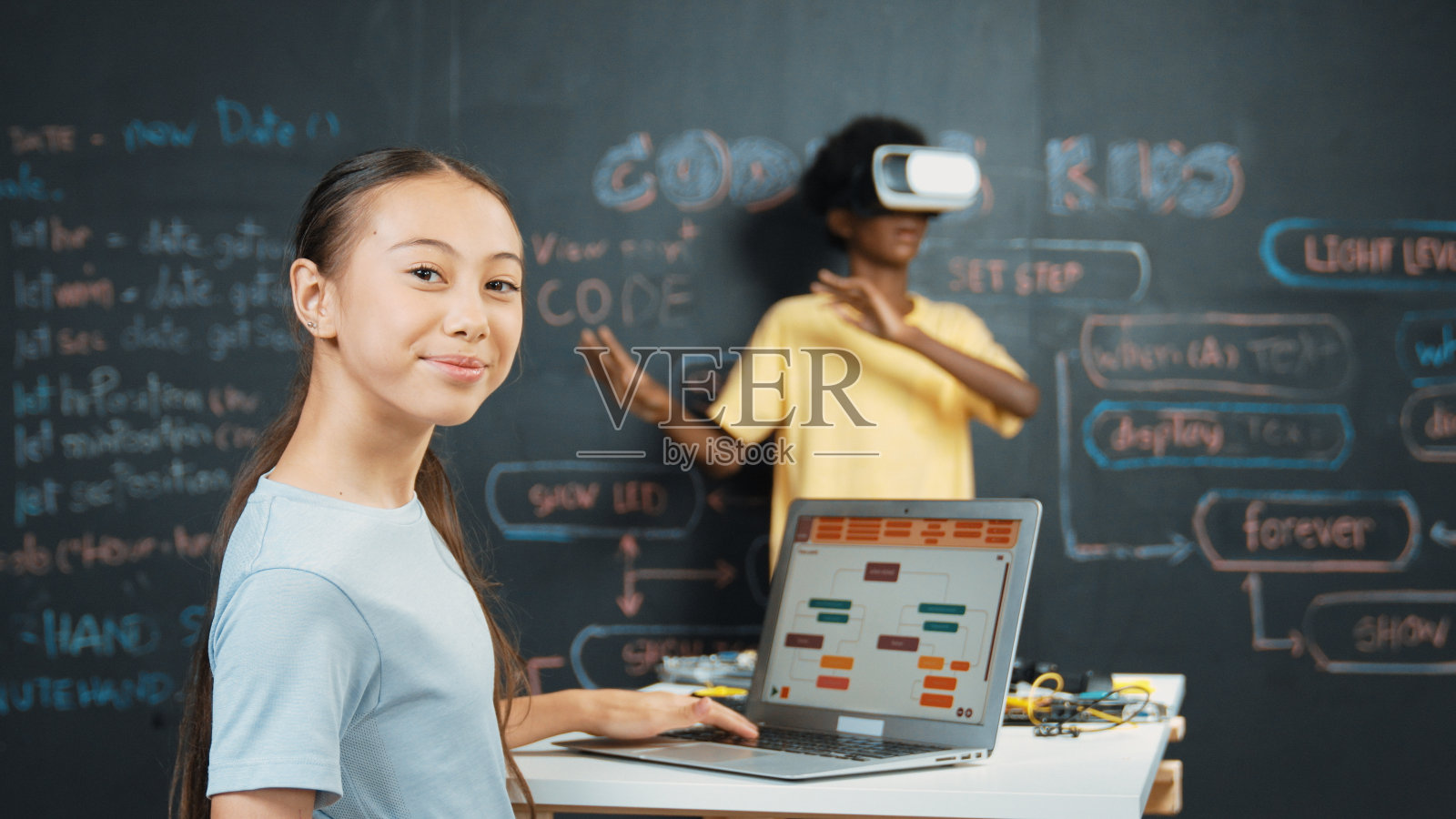 非洲男孩戴着虚拟现实眼镜,而年轻女子看着相机。启迪。照片摄影图片