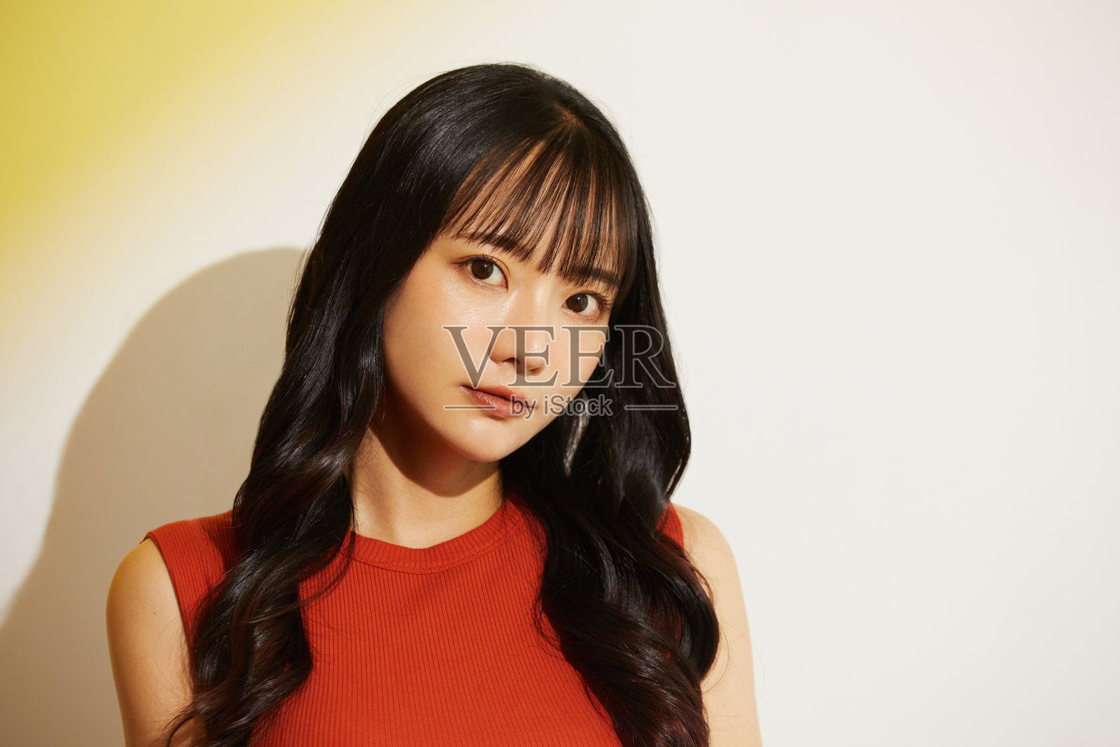 一个穿着鲜艳裙子的年轻女子的暖色调肖像照片摄影图片