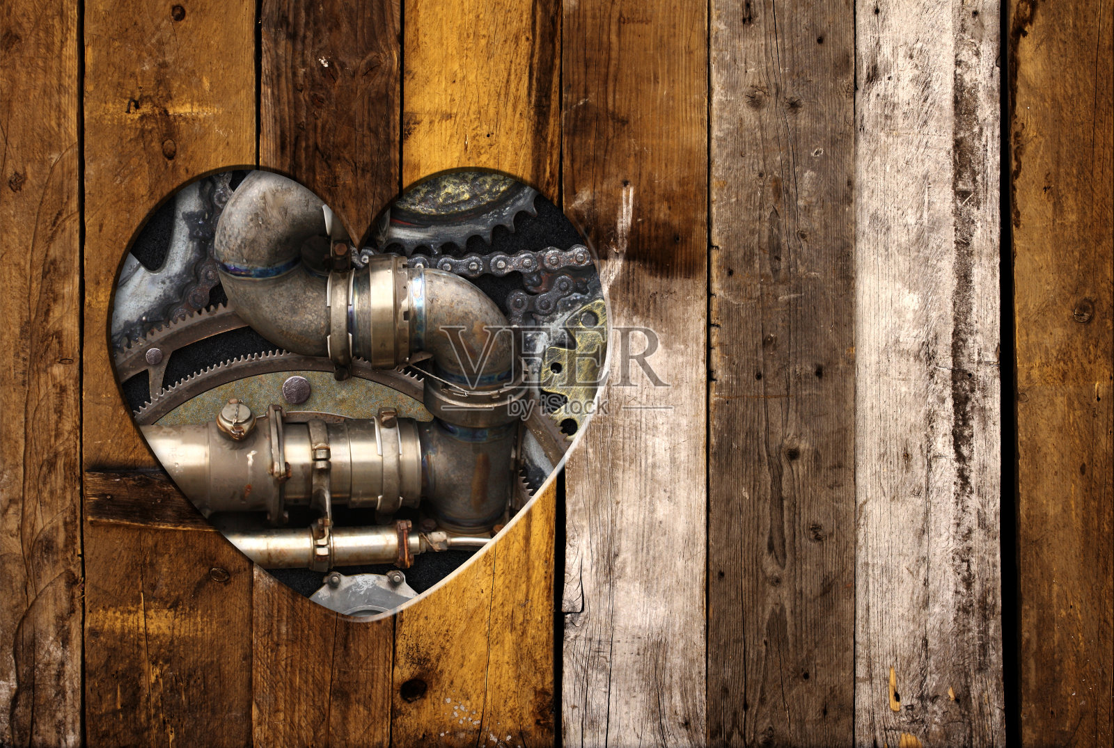 复古的背景在蒸汽朋克风格与心形孔在木板和复古的金属机器细节,管道,齿轮。文本的复制空间。可用于工业、机械设计照片摄影图片