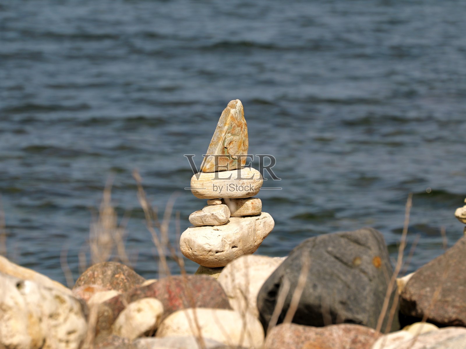 沙滩上堆积的石像照片摄影图片