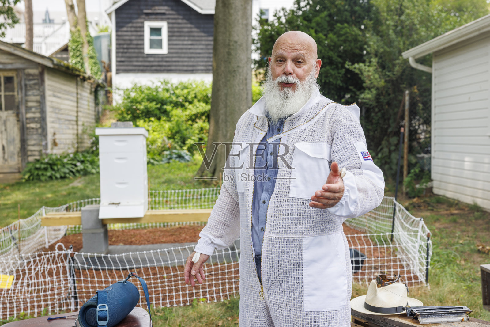 业余养蜂人展示他的后院蜂箱。资深拉丁裔男子分享对新泽西花园养蜂的热情。照片摄影图片