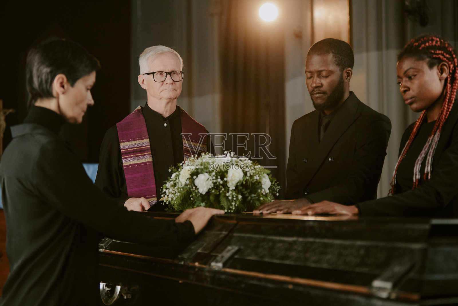 被人包围的黑色棺材照片摄影图片