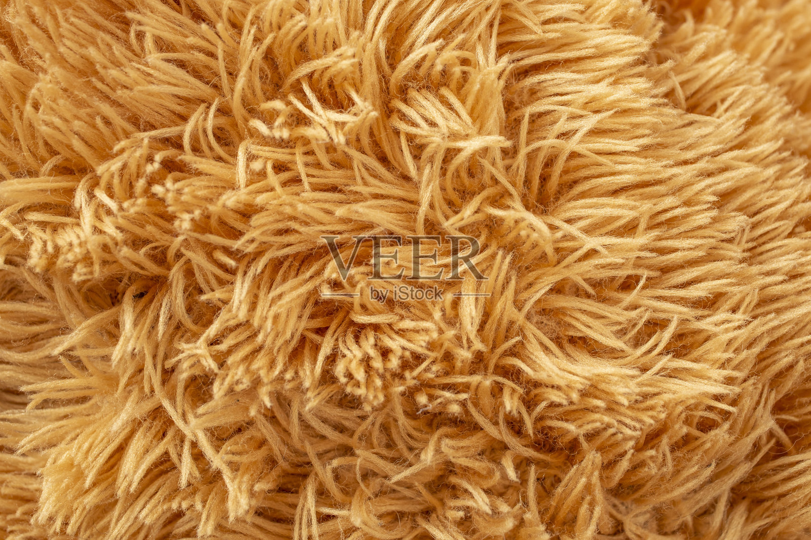 泰迪熊玩具蓬松的结构近景,棕色抽象的背景纹理照片摄影图片