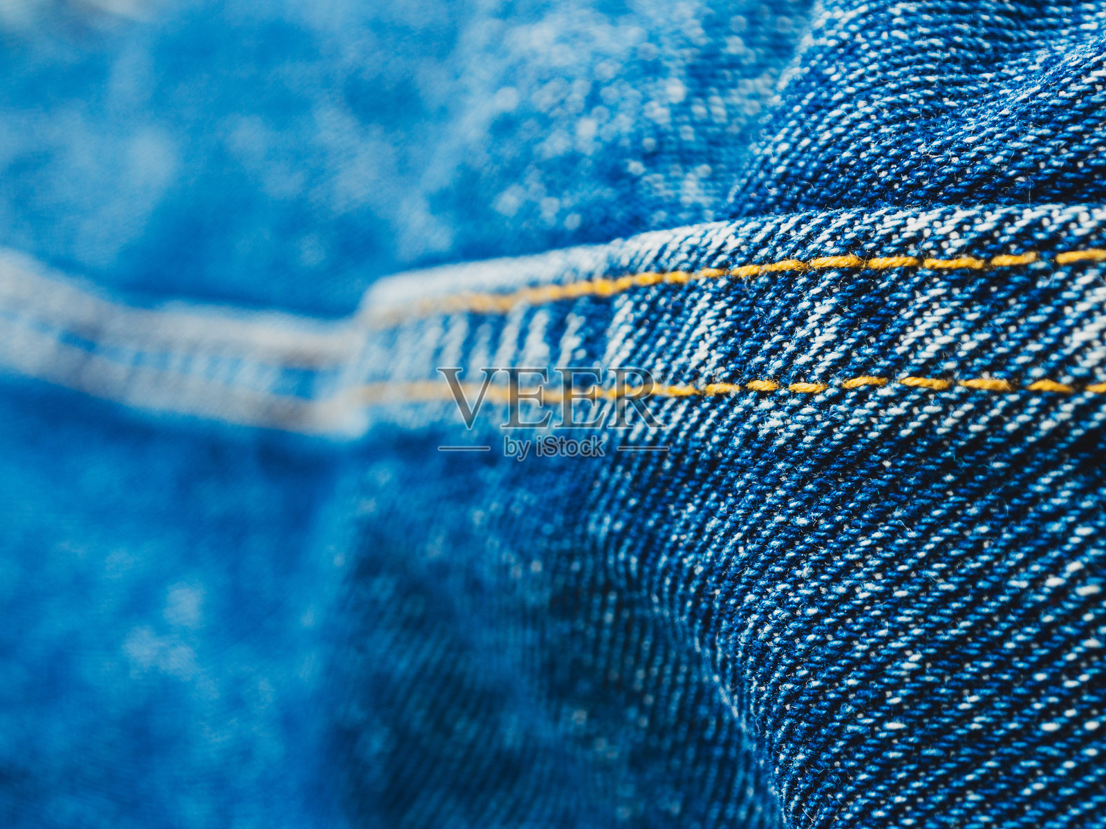牛仔的特写,突出纹理和细节。是时尚和纺织行业主题的绝佳选择照片摄影图片