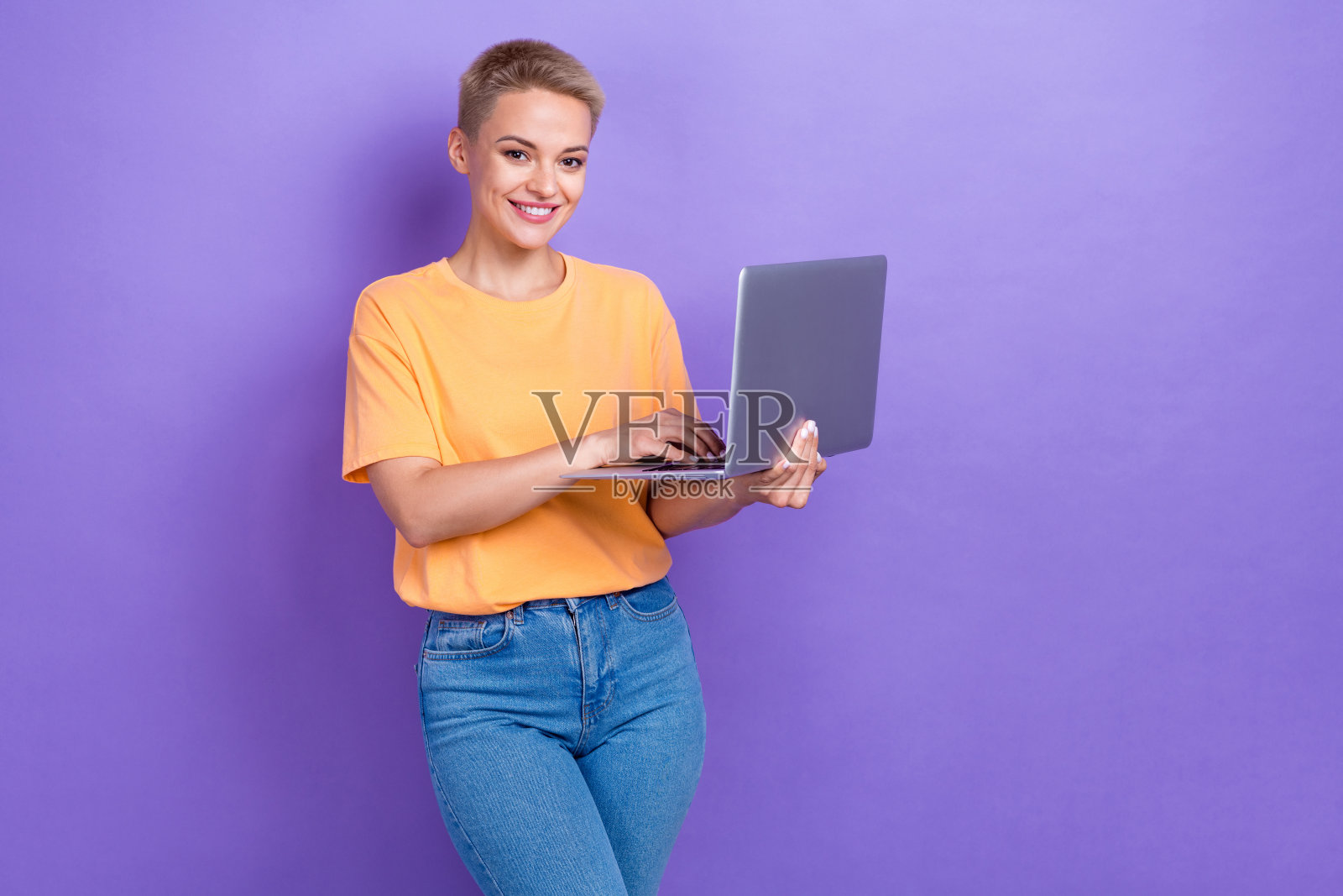 迷人的积极的人的肖像持有使用无线上网本孤立的紫色背景照片摄影图片