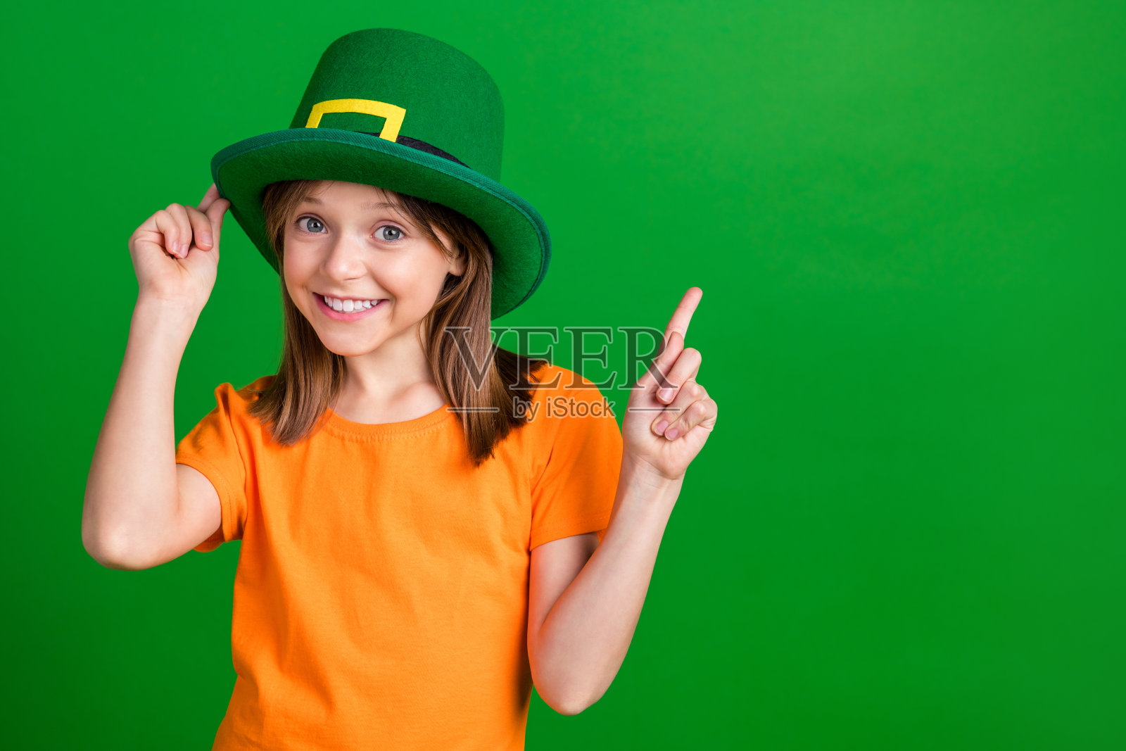 照片的小迷人的女孩触摸头饰表明手指空白空间孤立的绿色背景照片摄影图片