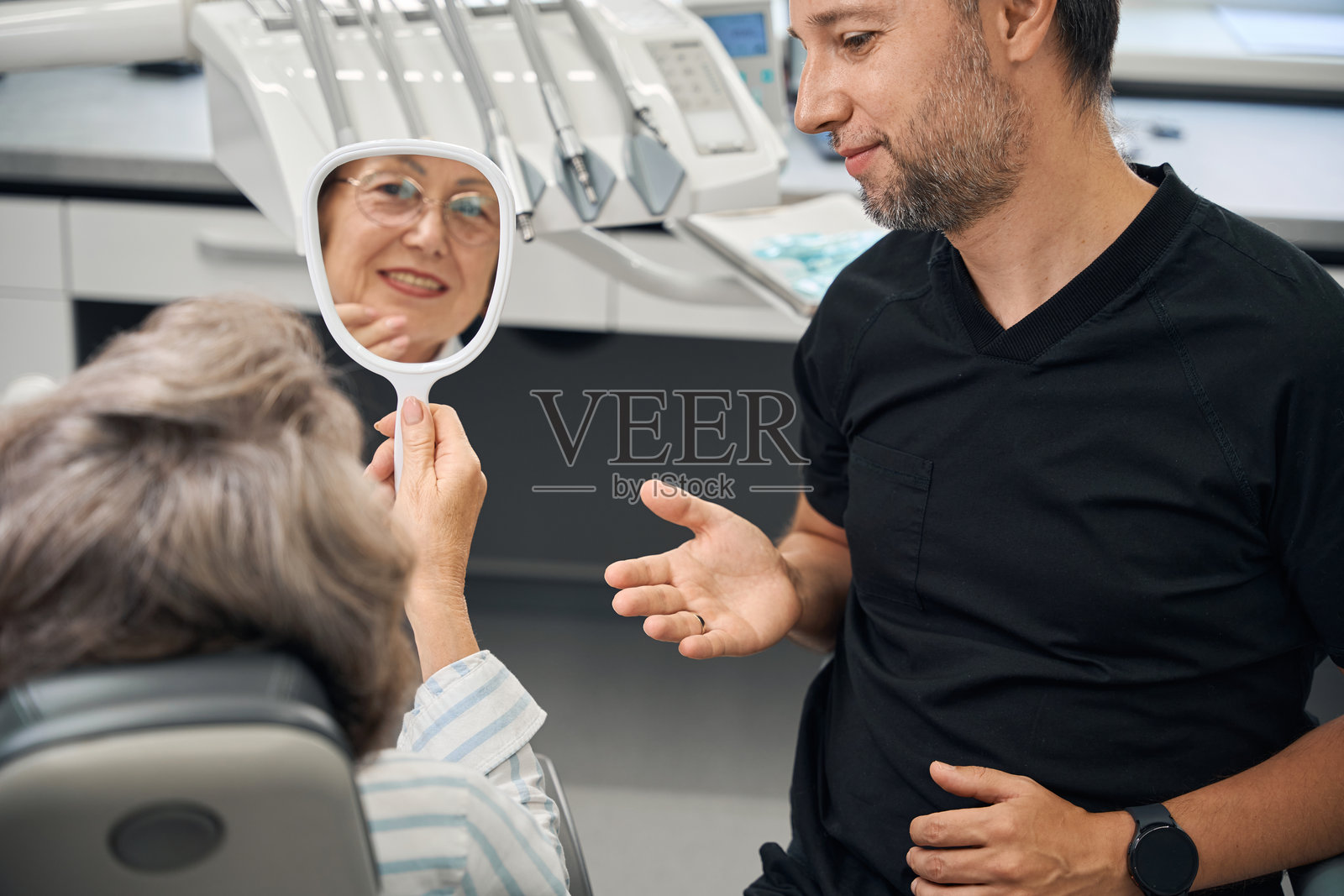 牙科诊所里的女士手里拿着镜子照片摄影图片