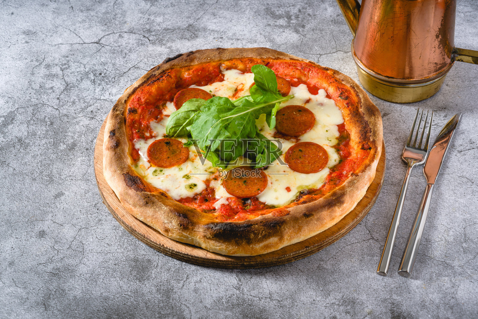 从上方俯视的那不勒斯披萨,上面有香肠、墨西哥辣椒和芝麻菜照片摄影图片