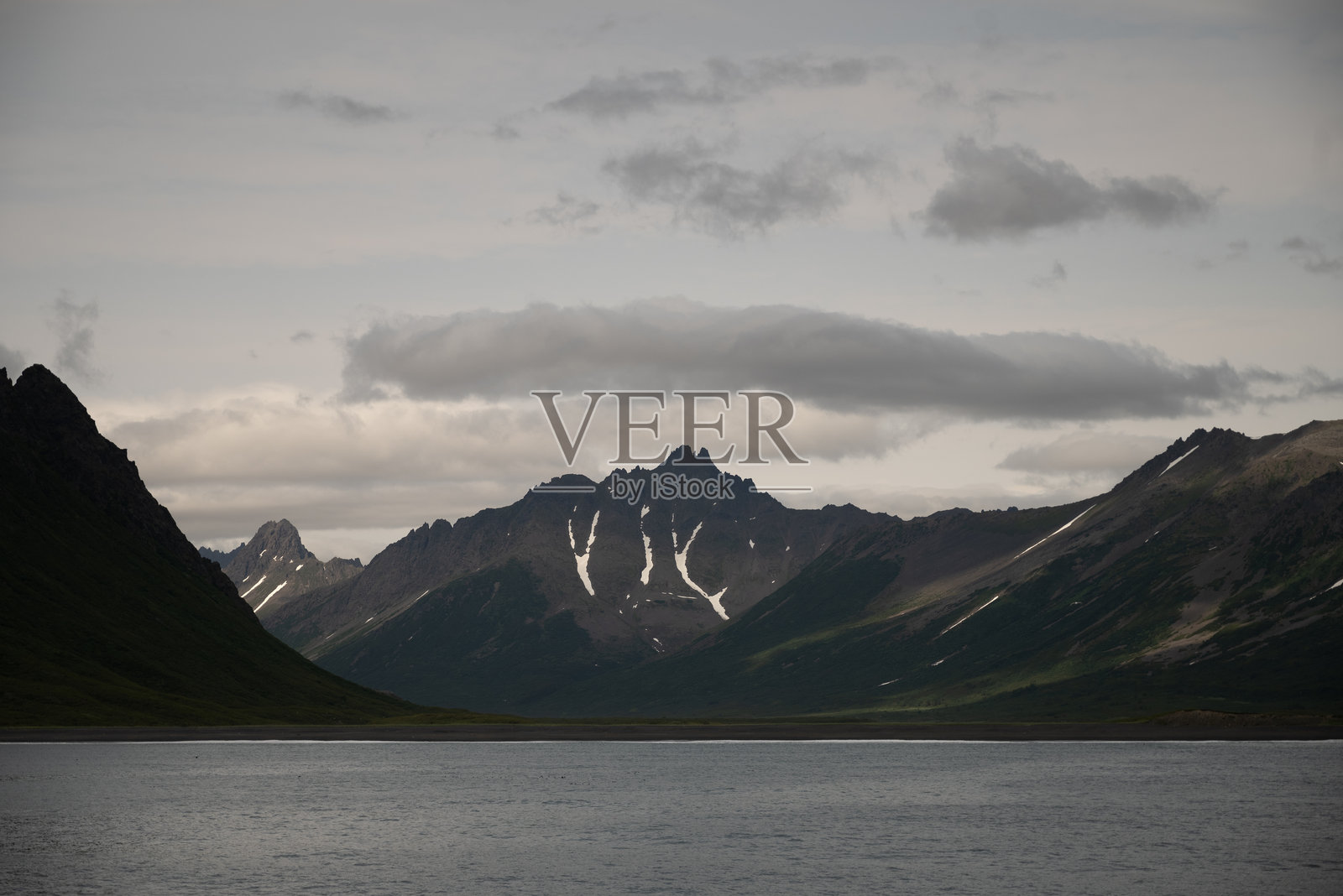 被雪山环绕的海湾,点缀着冰块。大自然在其冰冻的辉煌中展现出魔力。冰与海的独特结合。寒冷天气中的旅行,清新的空气。照片摄影图片