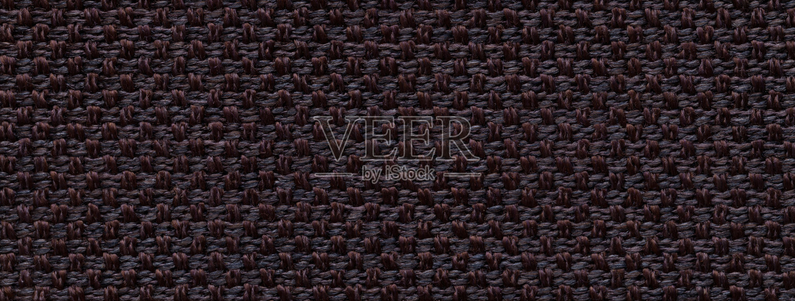 黑色和棕色的编织纺织材料背景,带有藤编图案,特写。古董颜色的面料照片摄影图片