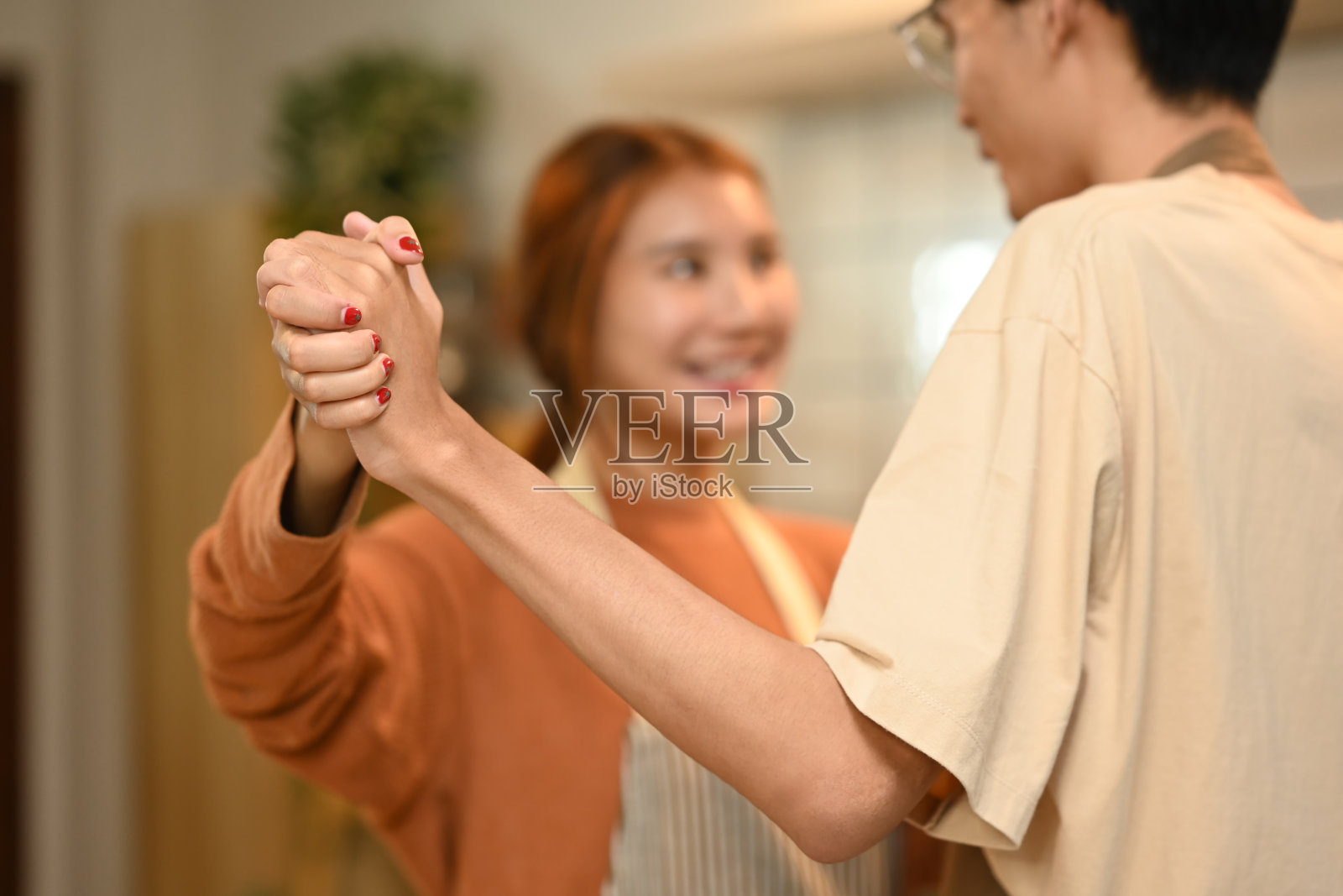 在厨房里跳舞的恩爱亚洲情侣,分享甜蜜快乐的时刻照片摄影图片