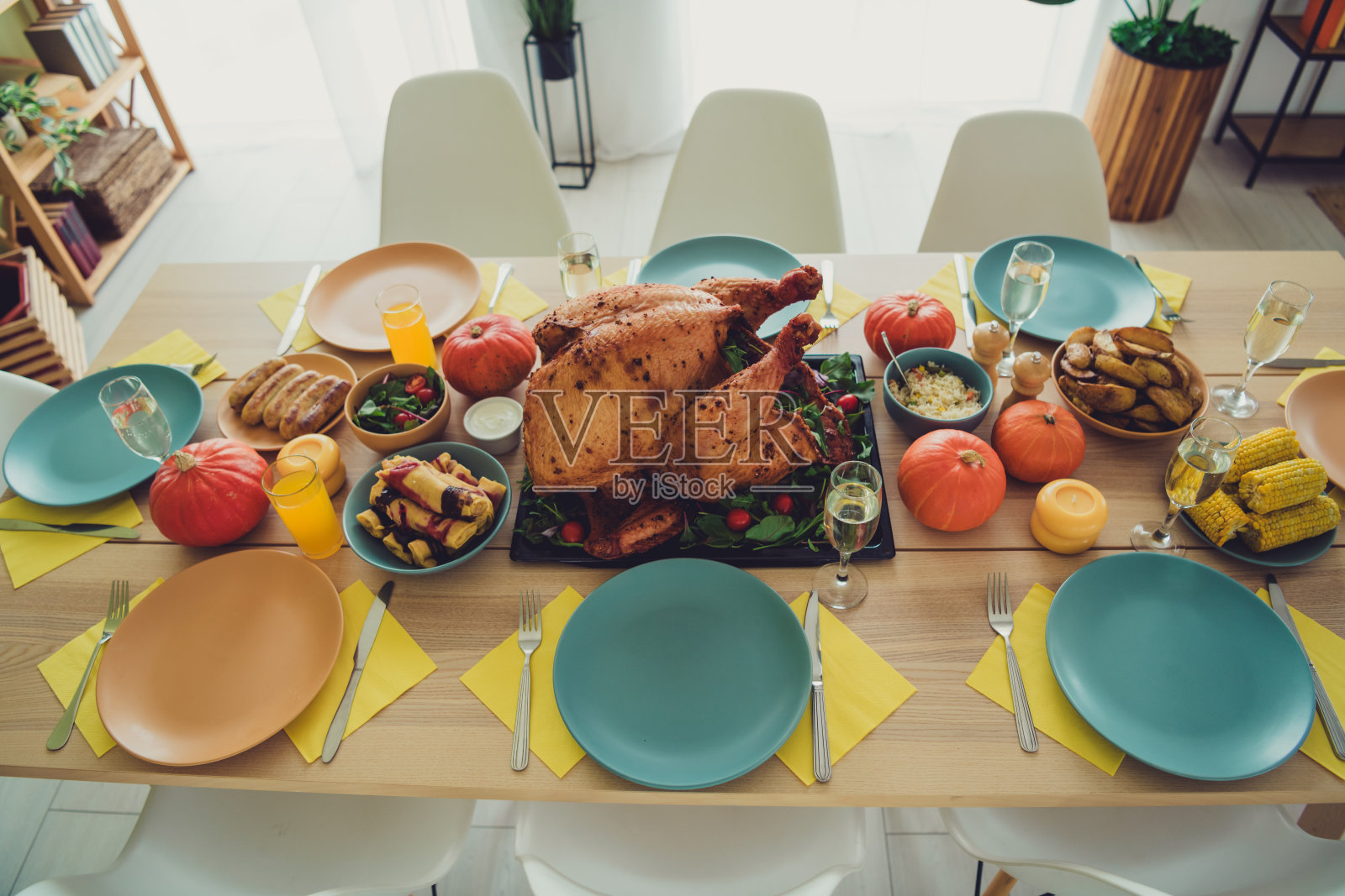 高角度拍摄的美味烤火鸡,摆放在感恩节家庭聚会的室内餐桌上照片摄影图片