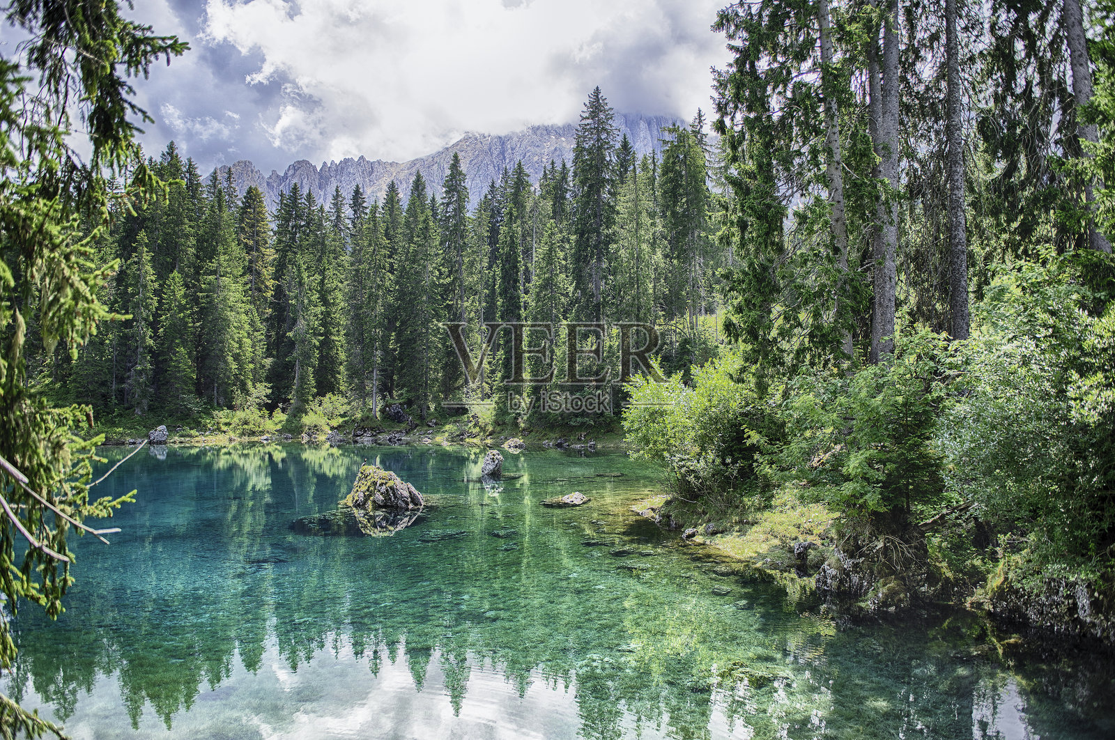 翡翠绿色的卡雷扎湖映照着意大利多洛米蒂山脉的拉泰马尔山照片摄影图片
