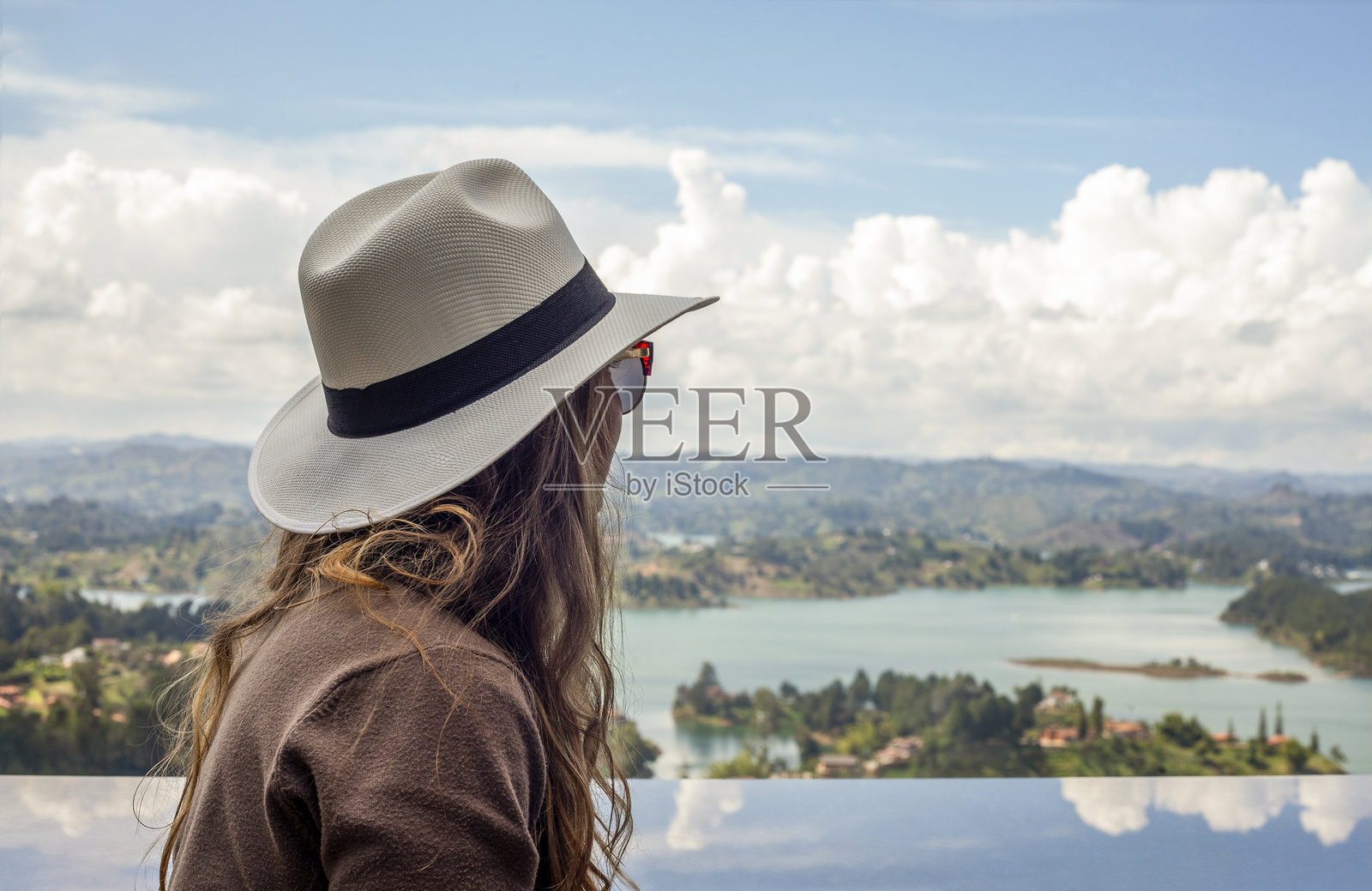 戴着帽子的女性欣赏哥伦比亚安蒂奥基亚的瓜塔佩美景照片摄影图片