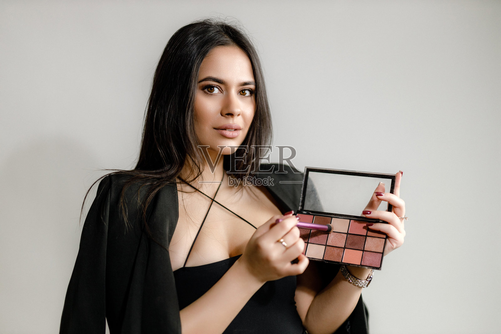 美丽的女性在化眼影妆照片摄影图片