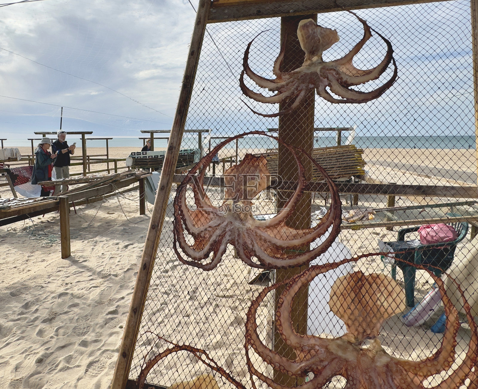 游客在纳扎雷海滩拍摄晒干的鱼照片摄影图片