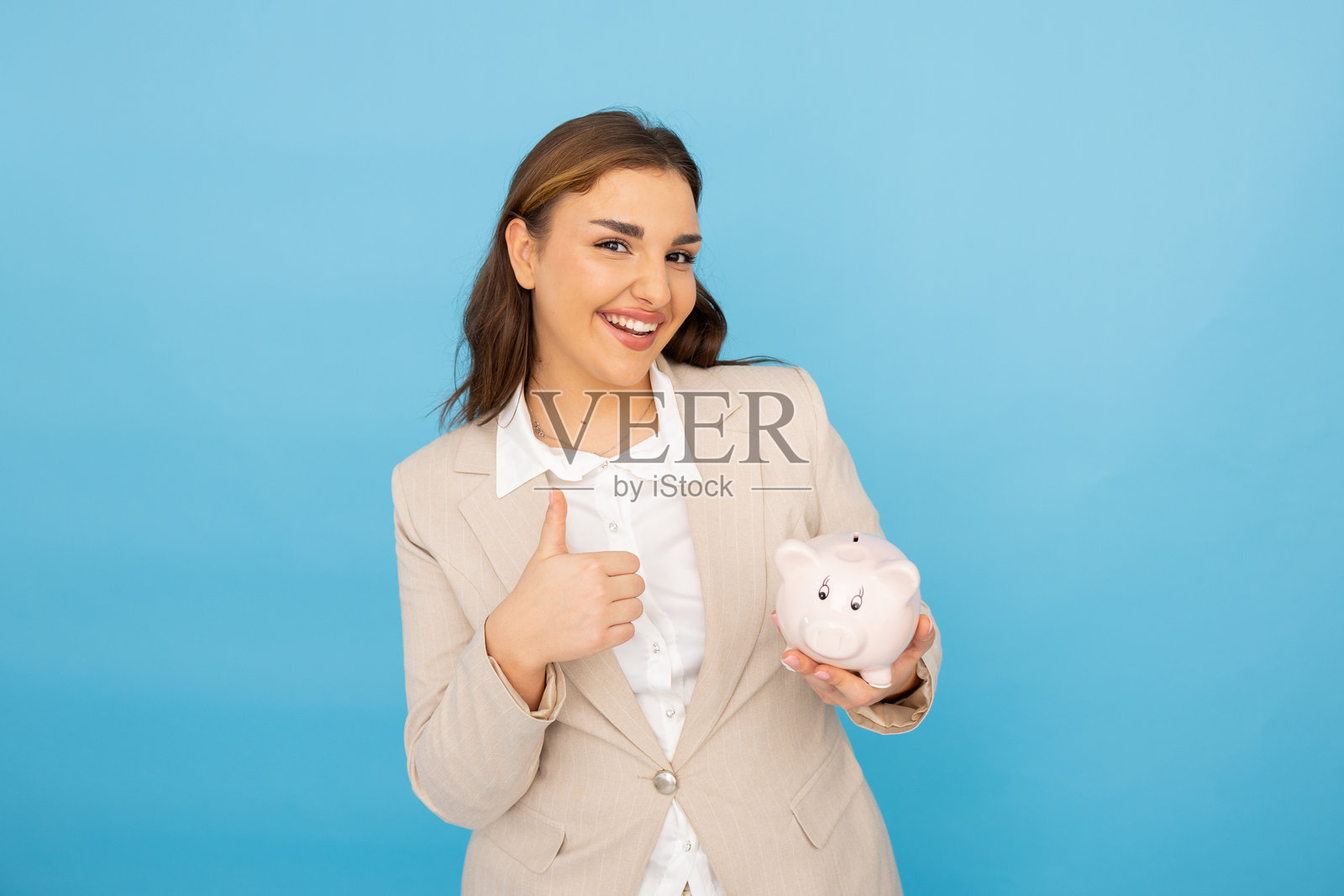 充满活力的年轻女性与储蓄罐一起追求财务目标照片摄影图片