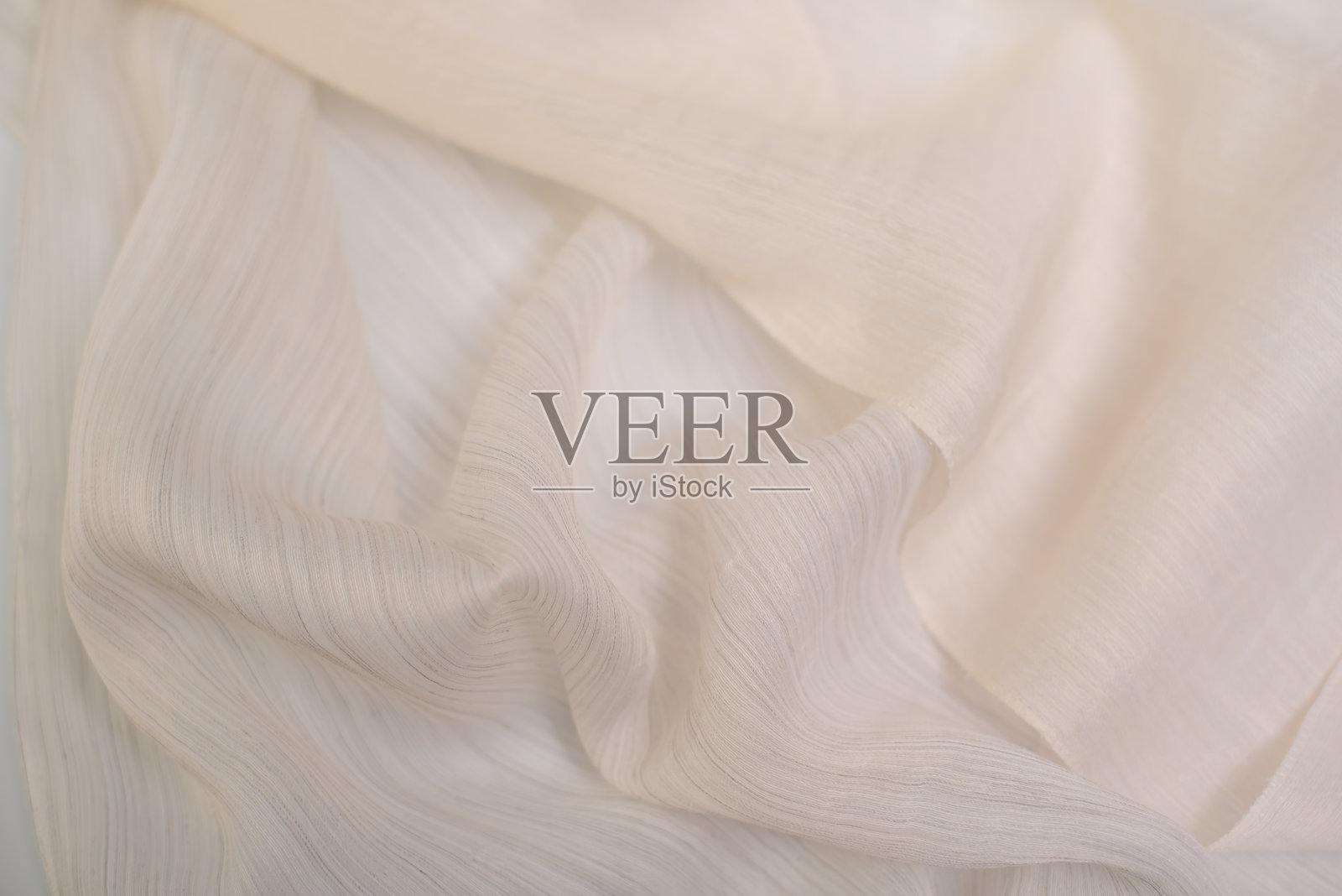 牛奶色的薄纱样品。轻盈透明的窗帘面料。照片摄影图片