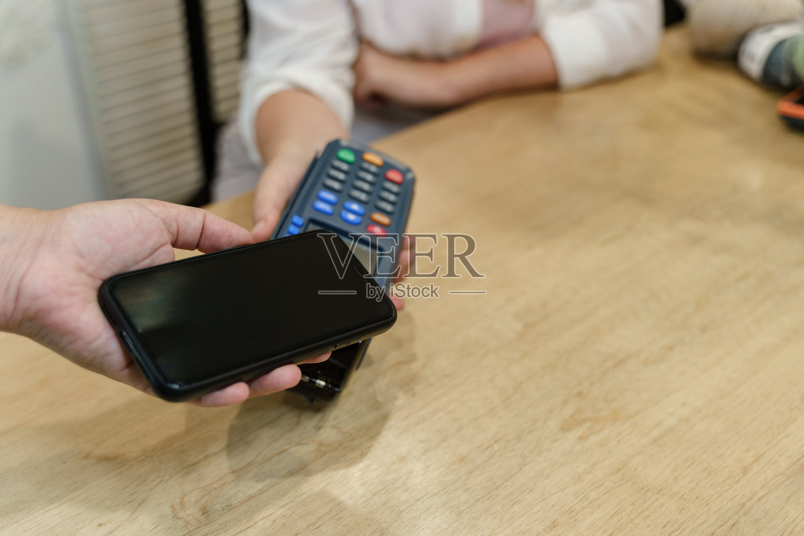 年轻顾客通过智能手机支付的手照片摄影图片