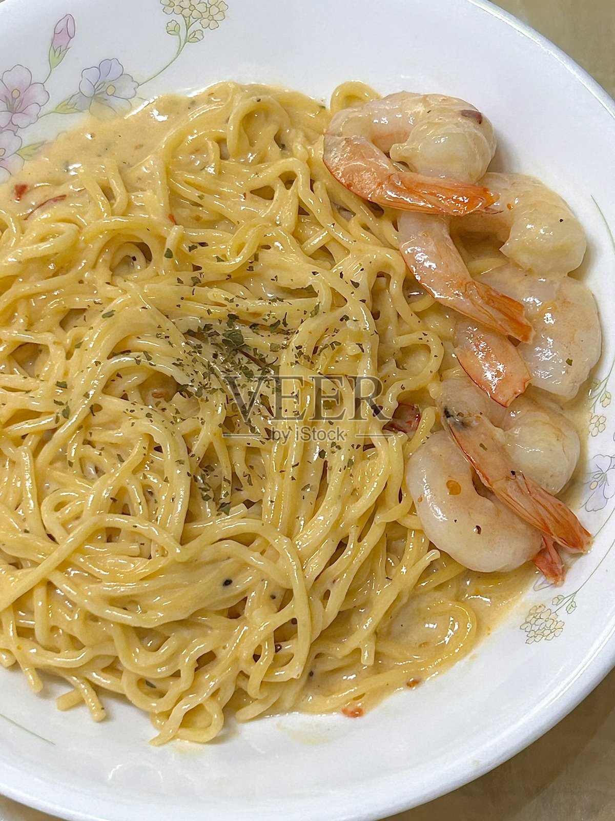 一盘完美煮熟的意大利面,上面浇有浓郁的番茄酱和新鲜的香草。非常适合食品摄影和菜单,生动展现意大利美食的魅力。照片摄影图片