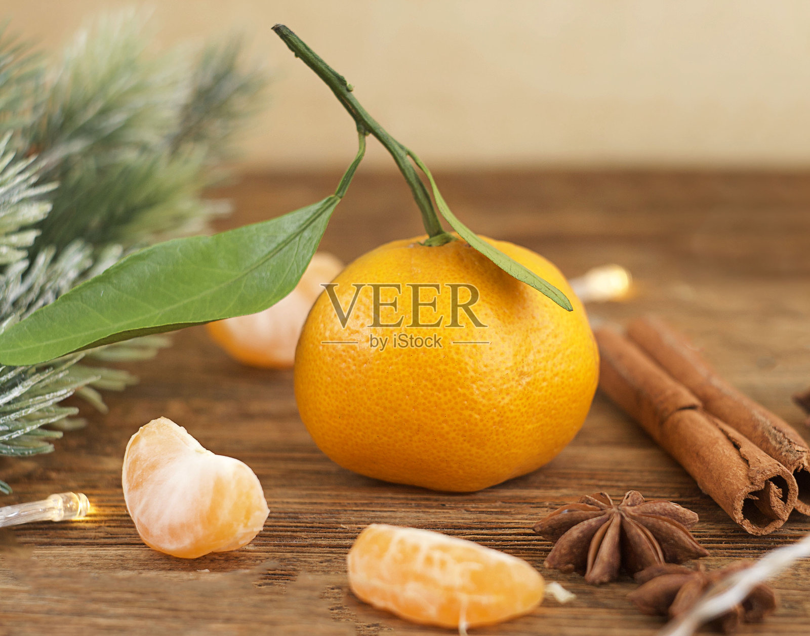 橘子、冷杉枝、肉桂和八角星散落在桌子上照片摄影图片
