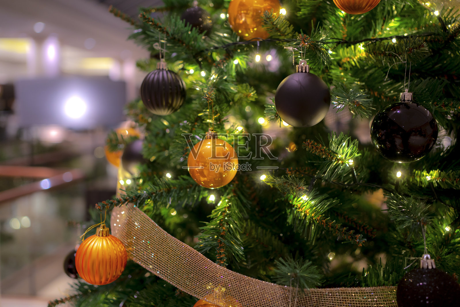 特写镜头展示了一棵装饰有金色和黑色亮丽玩具的圣诞树照片摄影图片