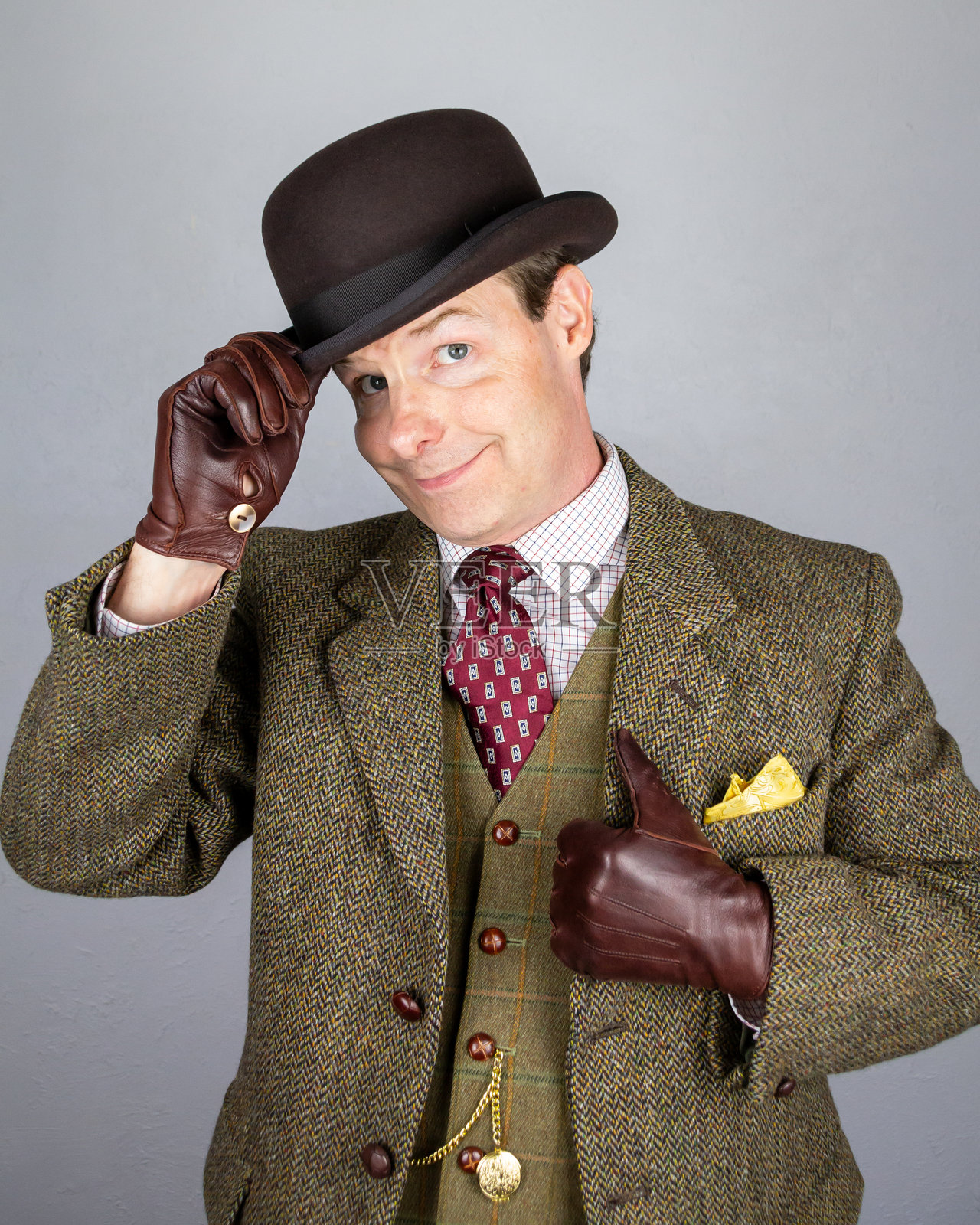 英俊的英国绅士礼貌地脱下圆顶礼帽致意照片摄影图片