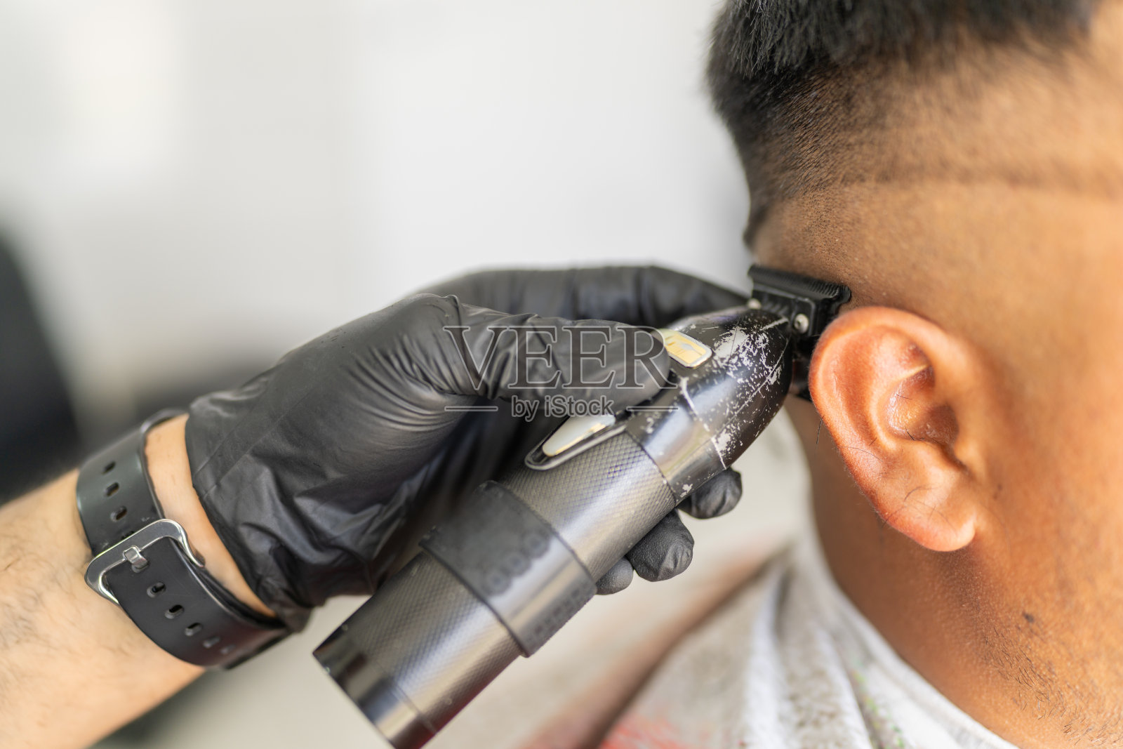 理发店里,理发师正在为顾客剪头发照片摄影图片