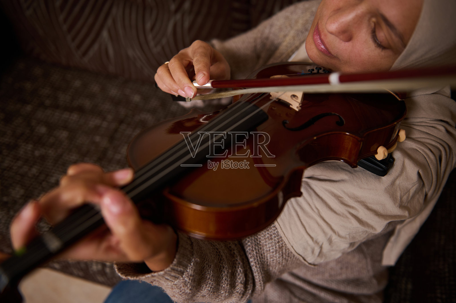 女人在舒适的室内环境中热情地拉小提琴照片摄影图片