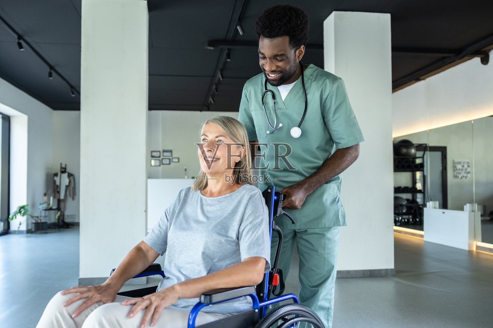 非裔美国护理人员在康复中心协助成年患者照片摄影图片