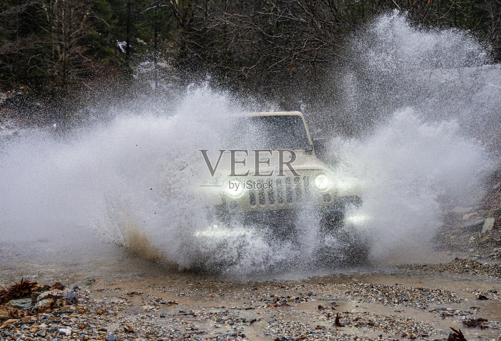 越野车穿过池塘沼泽中央,溅起水花照片摄影图片
