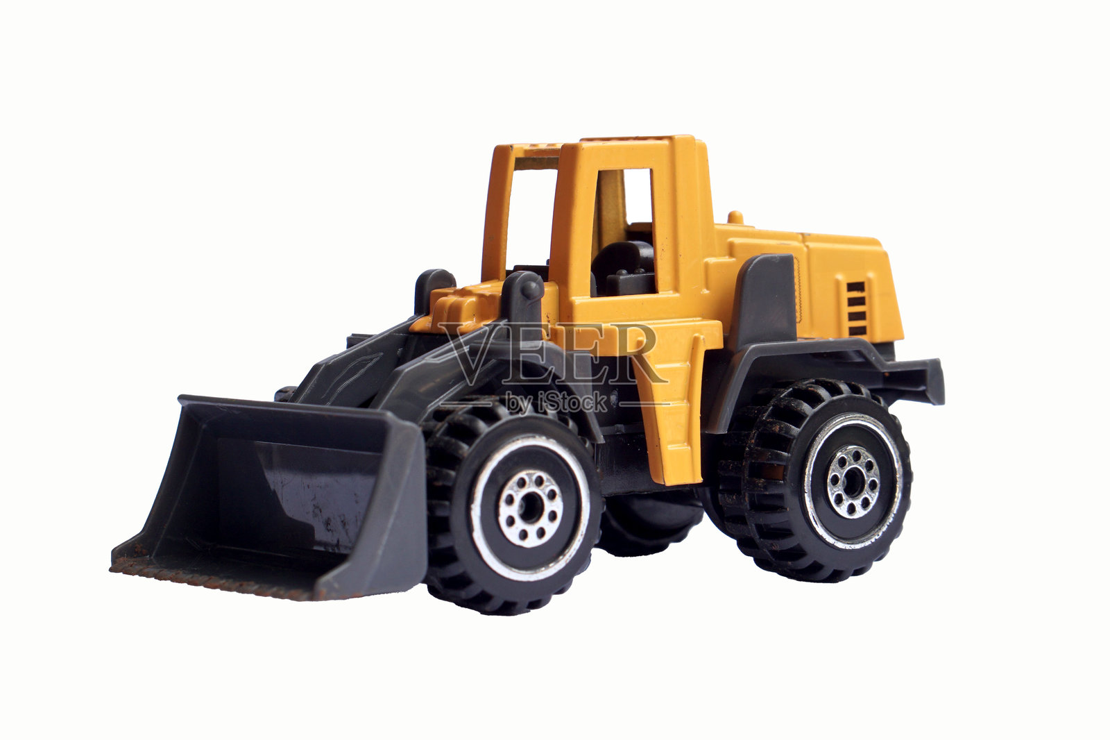 黄色玩具推土机的侧面视图,孤立在白色背景上,重型机械模型或压铸模型。照片摄影图片